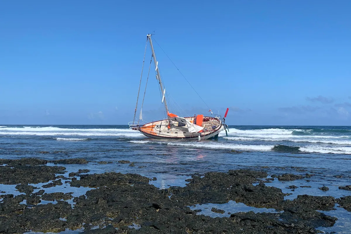 Golden Globe Race entrant Guy deBoer runs onto rocks at night in Canaries